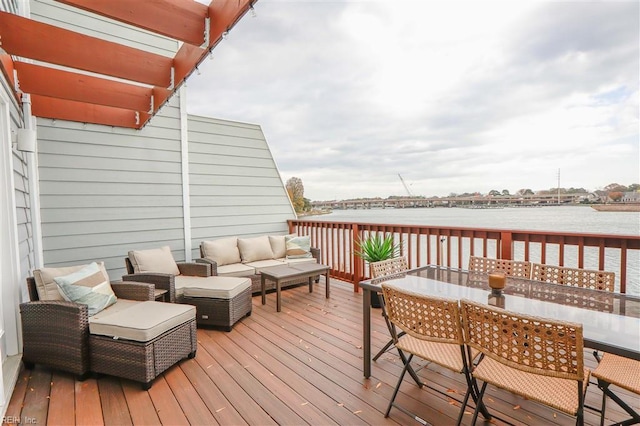 wooden deck featuring outdoor dining area, a water view, and an outdoor hangout area