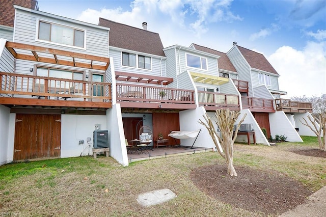 back of house featuring a shingled roof, a residential view, ac unit, a yard, and a deck