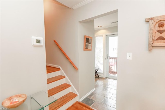 stairs with stone tile floors, visible vents, baseboards, and ornamental molding