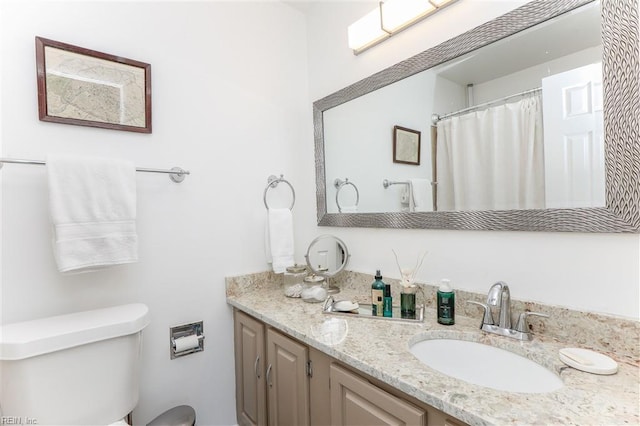 bathroom with toilet and vanity