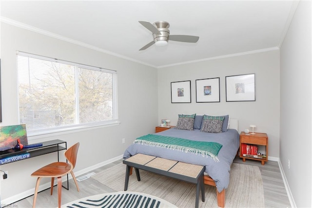 bedroom featuring ceiling fan, baseboards, light wood-style floors, and ornamental molding