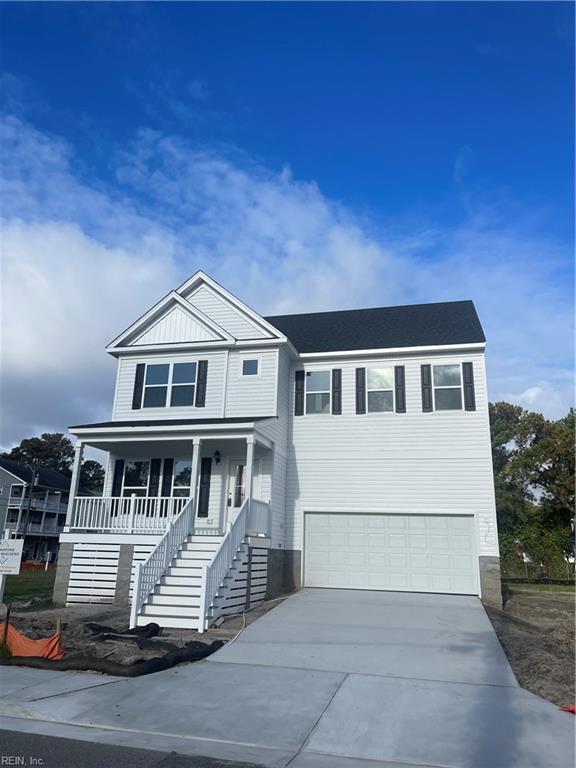 view of front of property with stairway, board and batten siding, covered porch, concrete driveway, and an attached garage