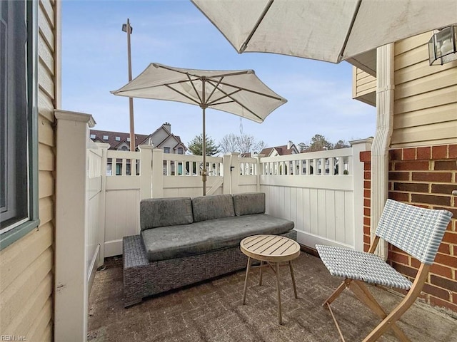 view of patio with an outdoor living space, a residential view, and fence