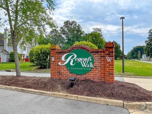 community / neighborhood sign with a lawn