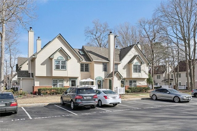 exterior space featuring uncovered parking and a chimney