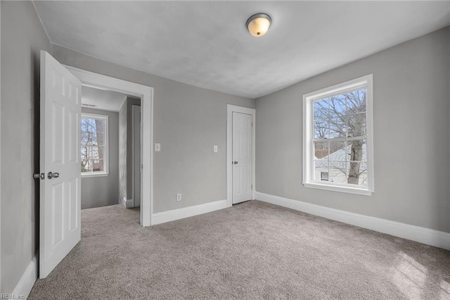 unfurnished bedroom with carpet and baseboards