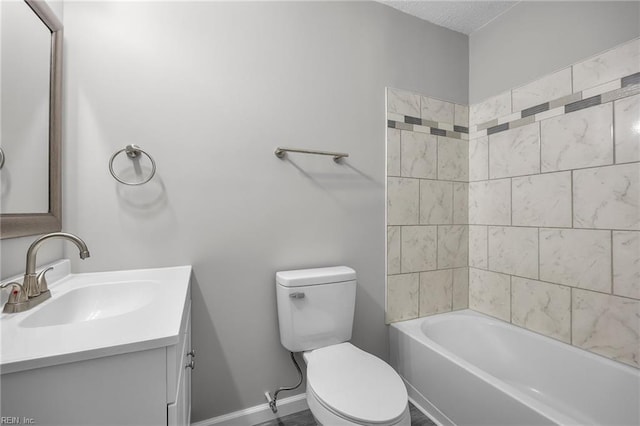 bathroom featuring vanity, toilet, tub / shower combination, and baseboards