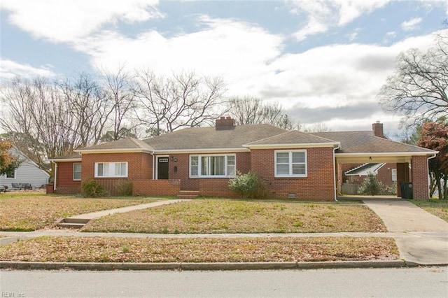 single story home with brick siding, a front lawn, concrete driveway, a chimney, and a carport