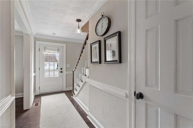 doorway to outside featuring visible vents, baseboards, stairway, ornamental molding, and dark wood-style floors