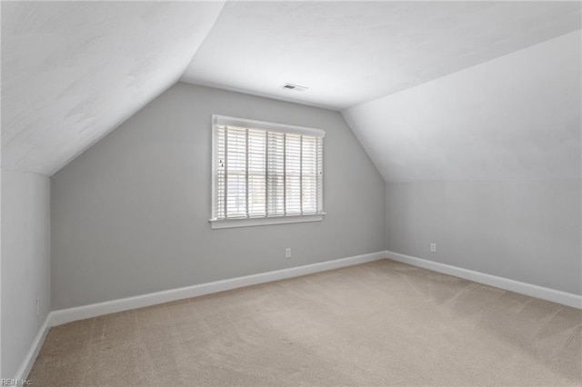 additional living space with visible vents, carpet flooring, and baseboards