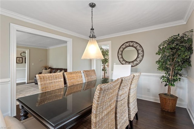 dining area featuring crown molding and dark wood-style flooring