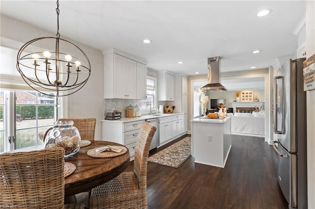 kitchen featuring dark wood-style floors, island exhaust hood, stainless steel appliances, light countertops, and open floor plan