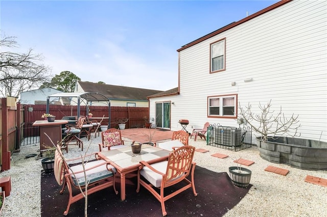 view of patio with a fenced backyard and outdoor dining space