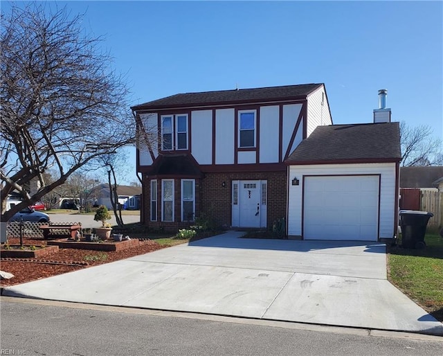 english style home featuring driveway, brick siding, an attached garage, and fence