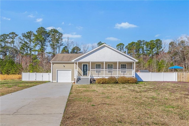 view of front of house featuring fence, concrete driveway, a front yard, covered porch, and a garage