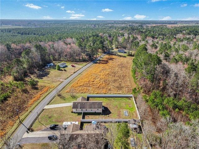 birds eye view of property with a view of trees