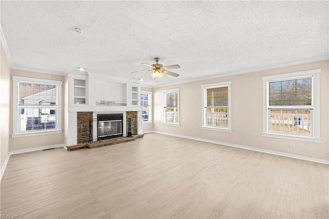 unfurnished living room featuring crown molding, light wood-style flooring, and ceiling fan