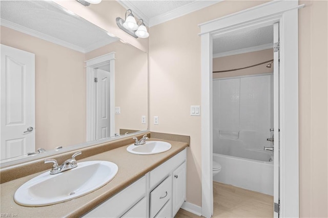 bathroom featuring a sink, toilet, and crown molding