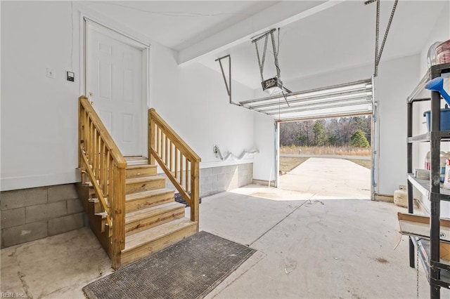 garage with concrete block wall and a garage door opener