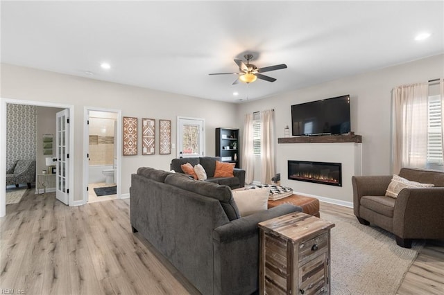 living room featuring a ceiling fan, light wood-style flooring, plenty of natural light, and recessed lighting