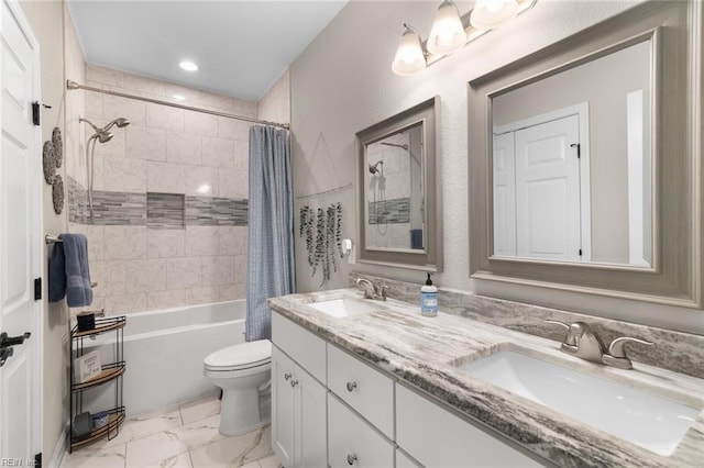 full bath with a sink, toilet, marble finish floor, and double vanity