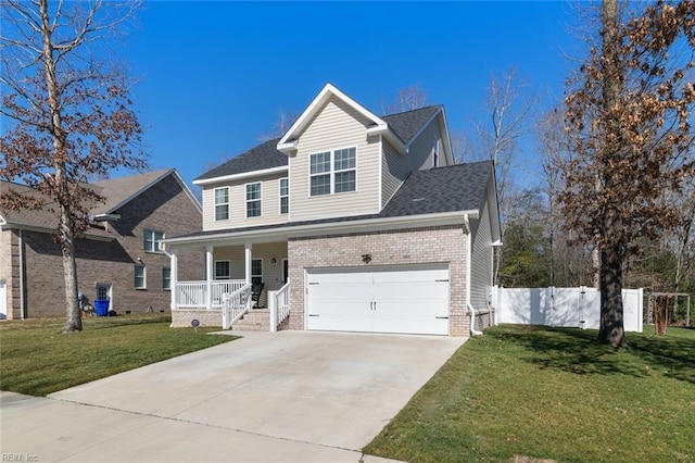 traditional-style house featuring fence, covered porch, a front lawn, concrete driveway, and brick siding