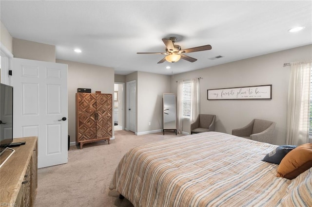 bedroom featuring visible vents, multiple windows, light colored carpet, and baseboards