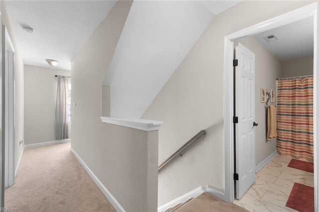 hall with visible vents, an upstairs landing, marble finish floor, and baseboards