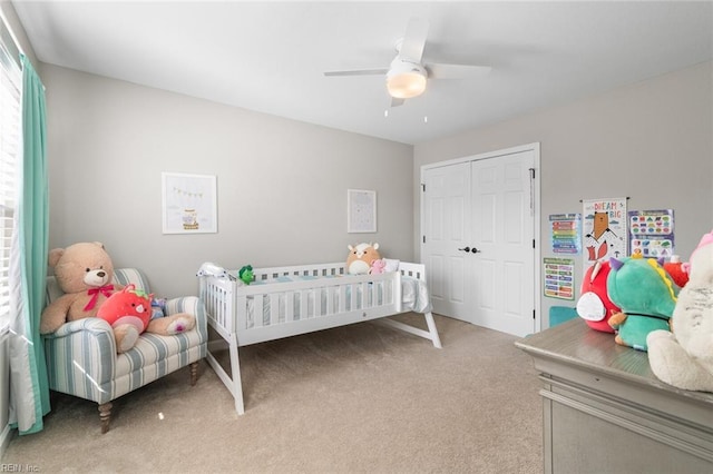 bedroom with light colored carpet, a closet, and ceiling fan