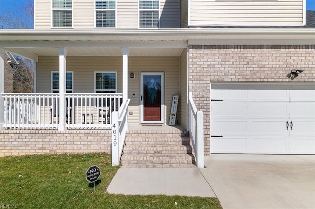 doorway to property featuring brick siding and a porch