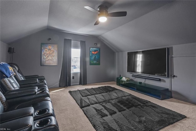 carpeted home theater room featuring lofted ceiling, a ceiling fan, and a textured ceiling