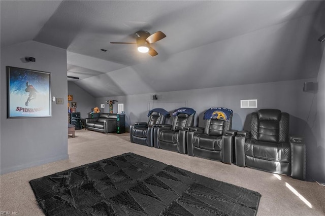 home theater room featuring carpet floors, a ceiling fan, visible vents, and vaulted ceiling