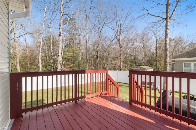 deck with a yard and fence