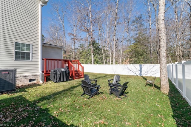 view of yard featuring a fenced backyard, central AC unit, and a deck