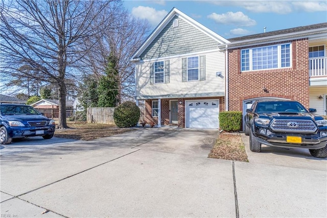 view of front of property featuring brick siding, an attached garage, concrete driveway, and fence