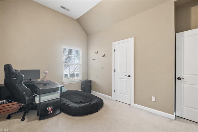 office space featuring visible vents, baseboards, carpet flooring, and vaulted ceiling