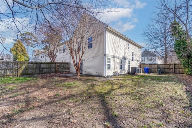 back of property featuring central air condition unit and a fenced backyard