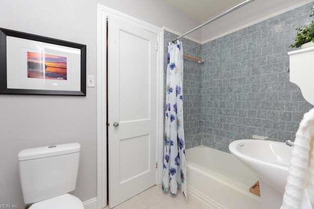 bathroom featuring tile patterned flooring, toilet, and shower / bath combo with shower curtain