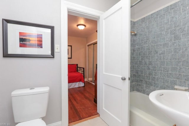 bathroom with tile patterned flooring, toilet, and tub / shower combination