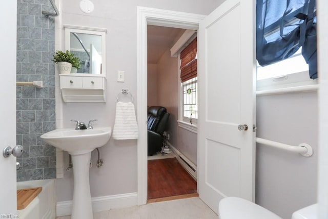 full bath featuring a sink, baseboards, toilet, and baseboard heating