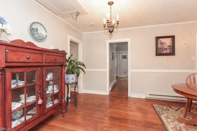 interior space featuring a baseboard heating unit, crown molding, wood finished floors, and a baseboard radiator