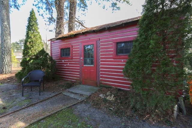 view of outbuilding with an outbuilding and fence