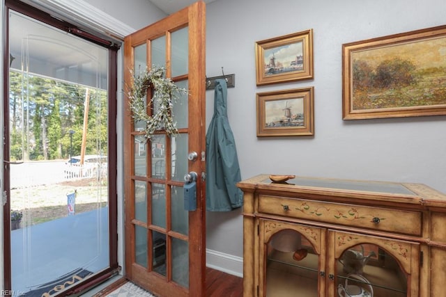 entryway with baseboards and wood finished floors