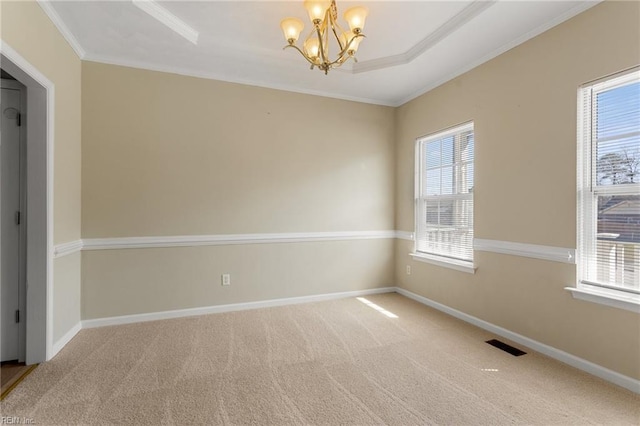 carpeted spare room with a notable chandelier, baseboards, and a wealth of natural light