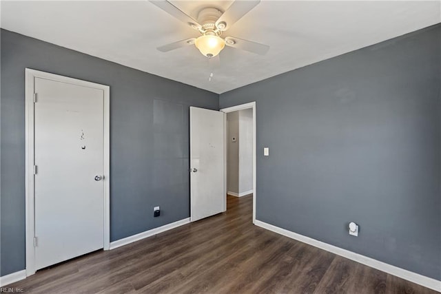 unfurnished bedroom featuring ceiling fan, baseboards, and dark wood-style flooring