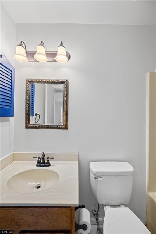 full bath with a washtub, toilet, and vanity