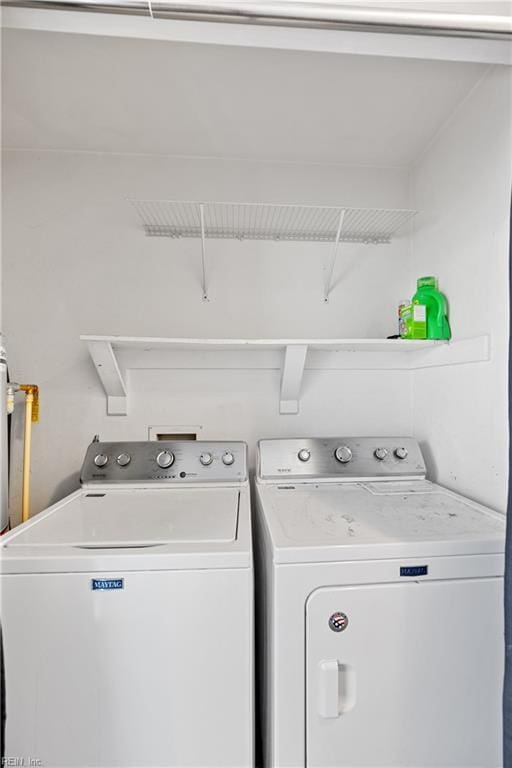 washroom featuring laundry area and washer and clothes dryer