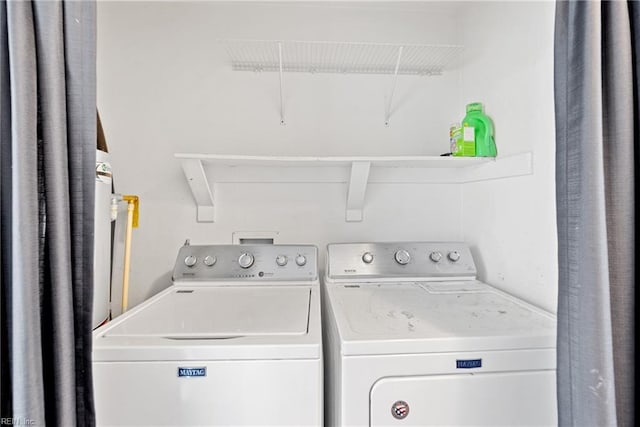 clothes washing area featuring laundry area, attic access, and separate washer and dryer