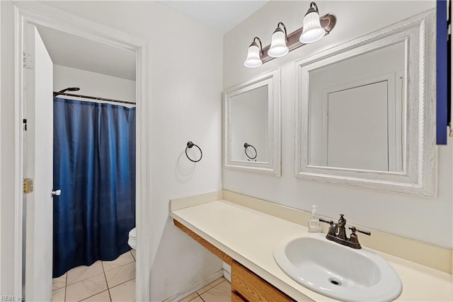 bathroom featuring vanity, toilet, and a shower with curtain