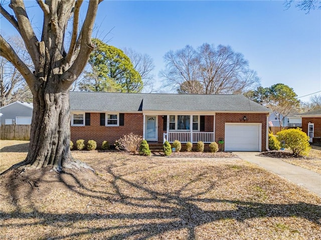 single story home featuring brick siding, a porch, an attached garage, and fence